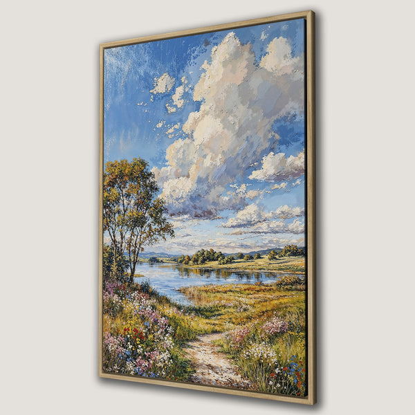 Framed Wall Art Canvas Print of a serene landscape painting. Features a blue sky with clouds, a river, and colorful wildflowers. Warm, inviting color palette.
