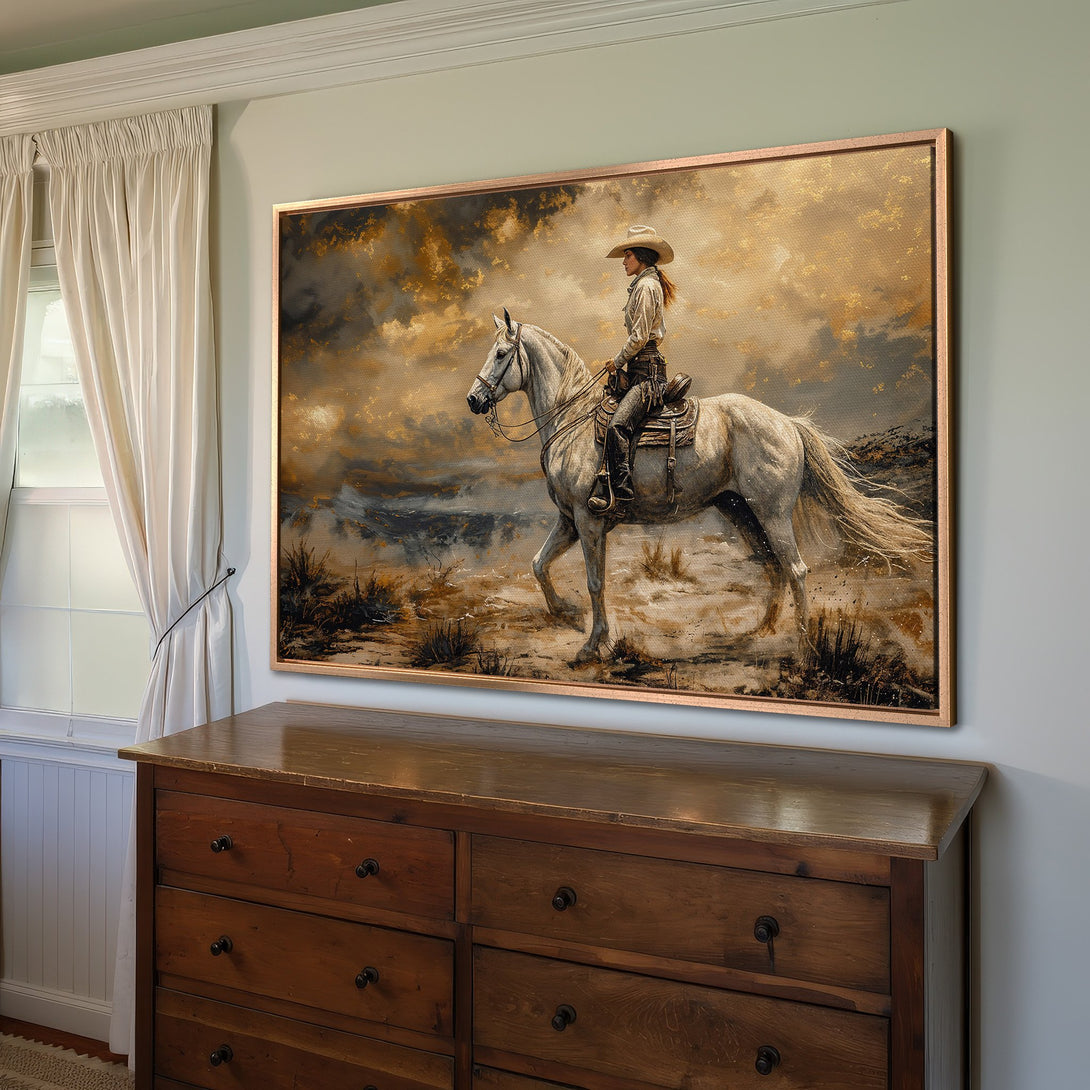 Framed Wall Art: Western-style canvas print of a cowgirl on a white horse. Warm, earthy tones with a touch of gold. Perfect for rustic home decor.