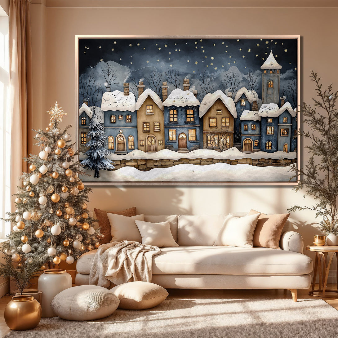 Framed Wall Art of a winter village scene in blue and beige tones. Perfect for cozy holiday decor.