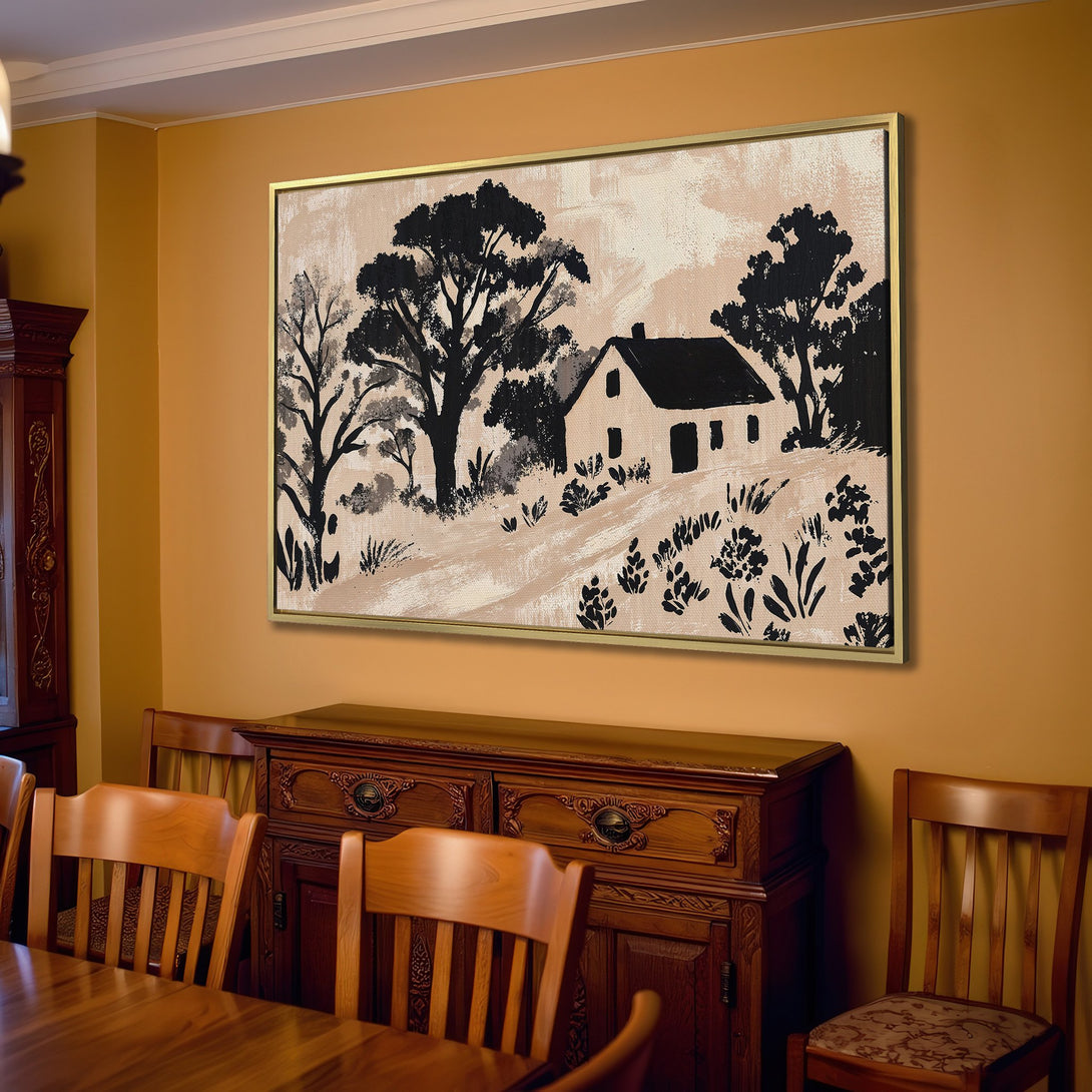 Canvas Print of a rustic farmhouse landscape in black and beige, displayed in a cozy living room with neutral tones.