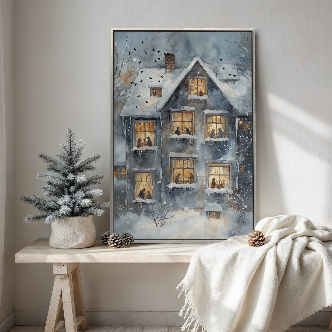 Framed Wall Art: Watercolor painting of a snowy winter house with warm interior lights. Blue and gray tones create a cozy, inviting atmosphere. Perfect for holiday decor.