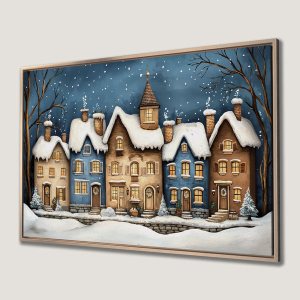 Framed Wall Art of a charming winter village scene with snow-covered houses, warm lighting, and a blue and brown color palette. Perfect holiday decor!