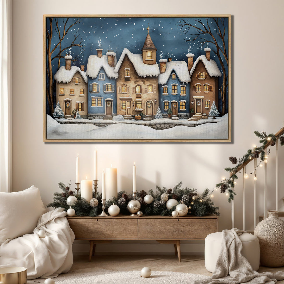 Framed Wall Art: Winter village scene in blue and beige tones. Cozy artwork perfect for holiday decor and adding warmth to any space.