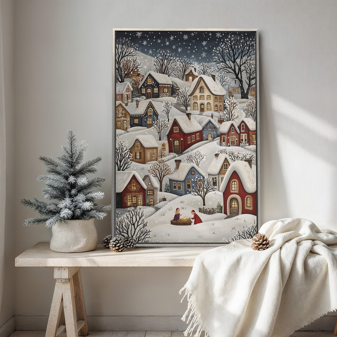 Framed Wall Art: Charming winter village scene in a whimsical style, featuring snow-covered houses. Warm, inviting color palette with blues, reds, and golds.