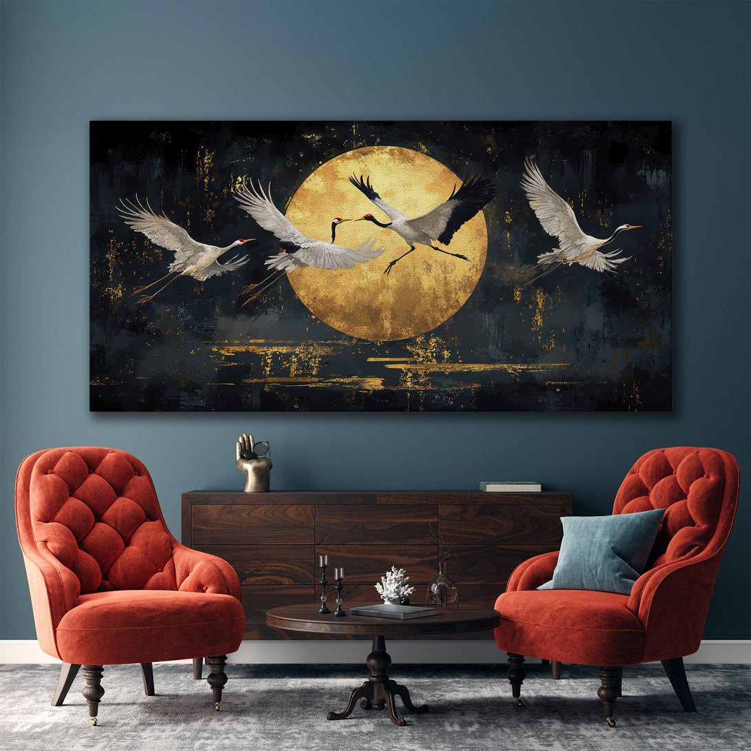 Framed Wall Art featuring cranes in flight against a golden moon. Elegant, modern style with a dark, moody color palette. Perfect for living room decor.