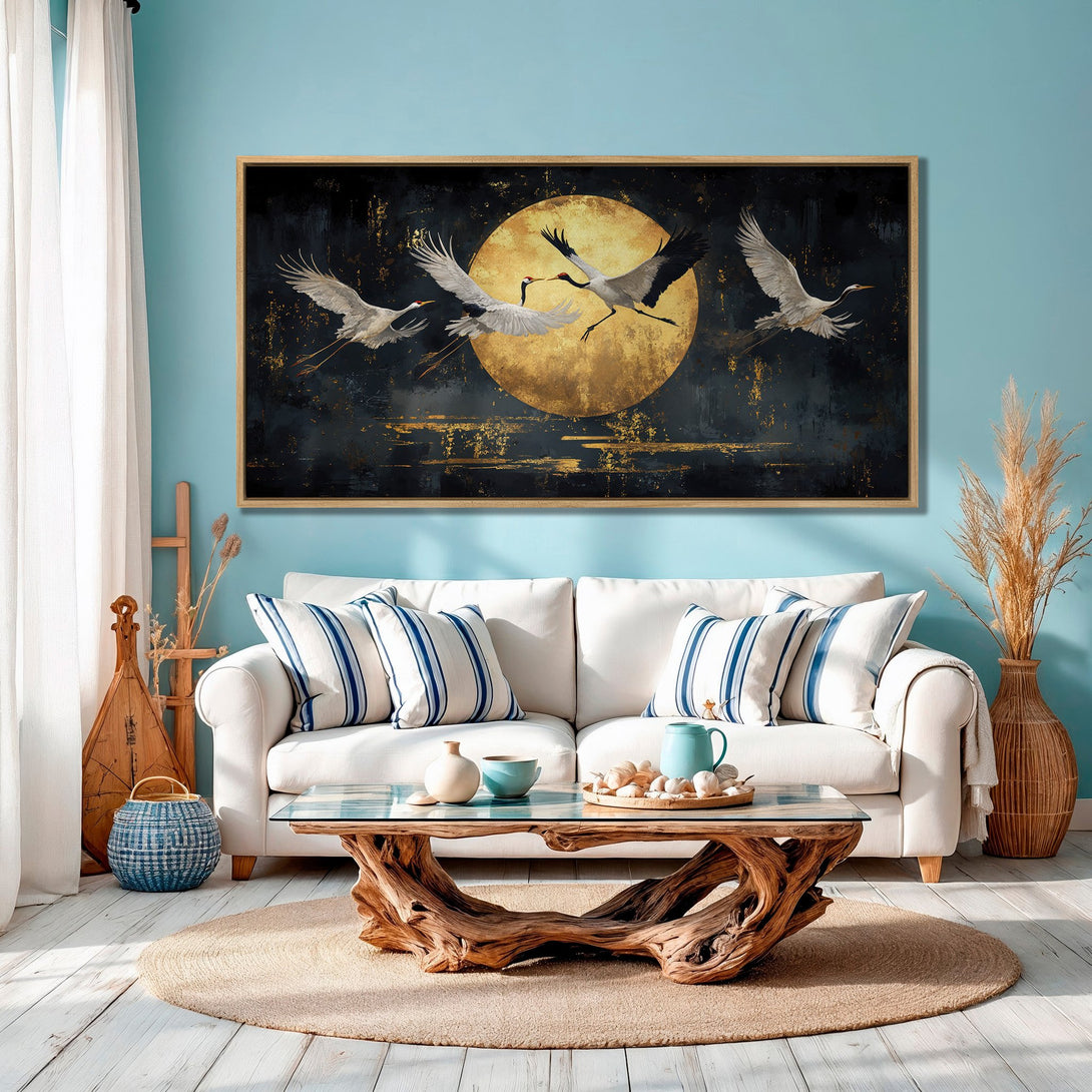 Framed Wall Art: Cranes flying in front of a golden moon. Modern, abstract style with a dark, gold, and teal color palette. Perfect for living room decor.