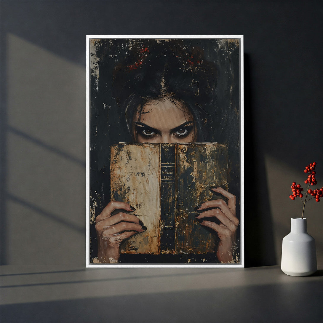 Framed Wall Art: Dark portrait of a woman with piercing eyes, holding an old book. Dramatic style with a moody, dark color palette. Perfect for gothic decor.
