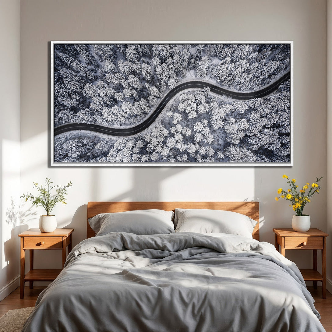 Framed Wall Art: Aerial view of snowy forest road. Modern landscape Canvas Print with a cool blue and white color palette. Perfect bedroom decor.