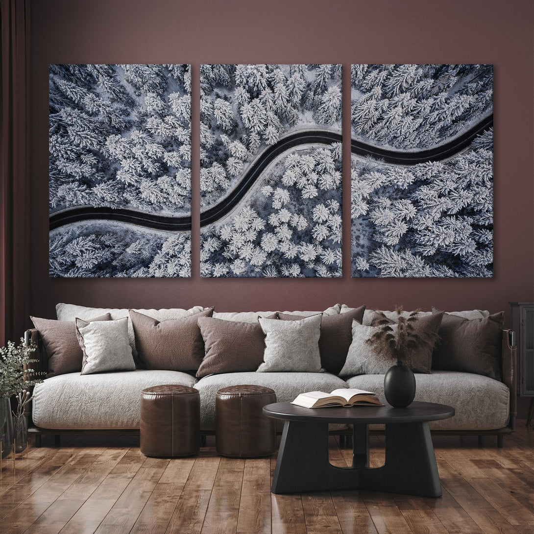 Canvas Print of a snowy forest road. Dramatic aerial view in cool blue and white tones. Modern wall art for your home.