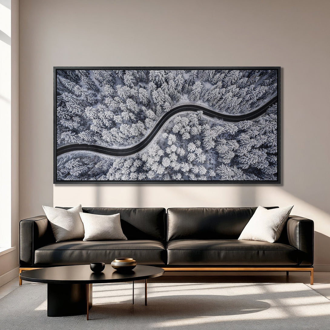 Framed Wall Art: Aerial view of snowy forest road. Modern style, cool blue and white palette. Perfect for living room decor.