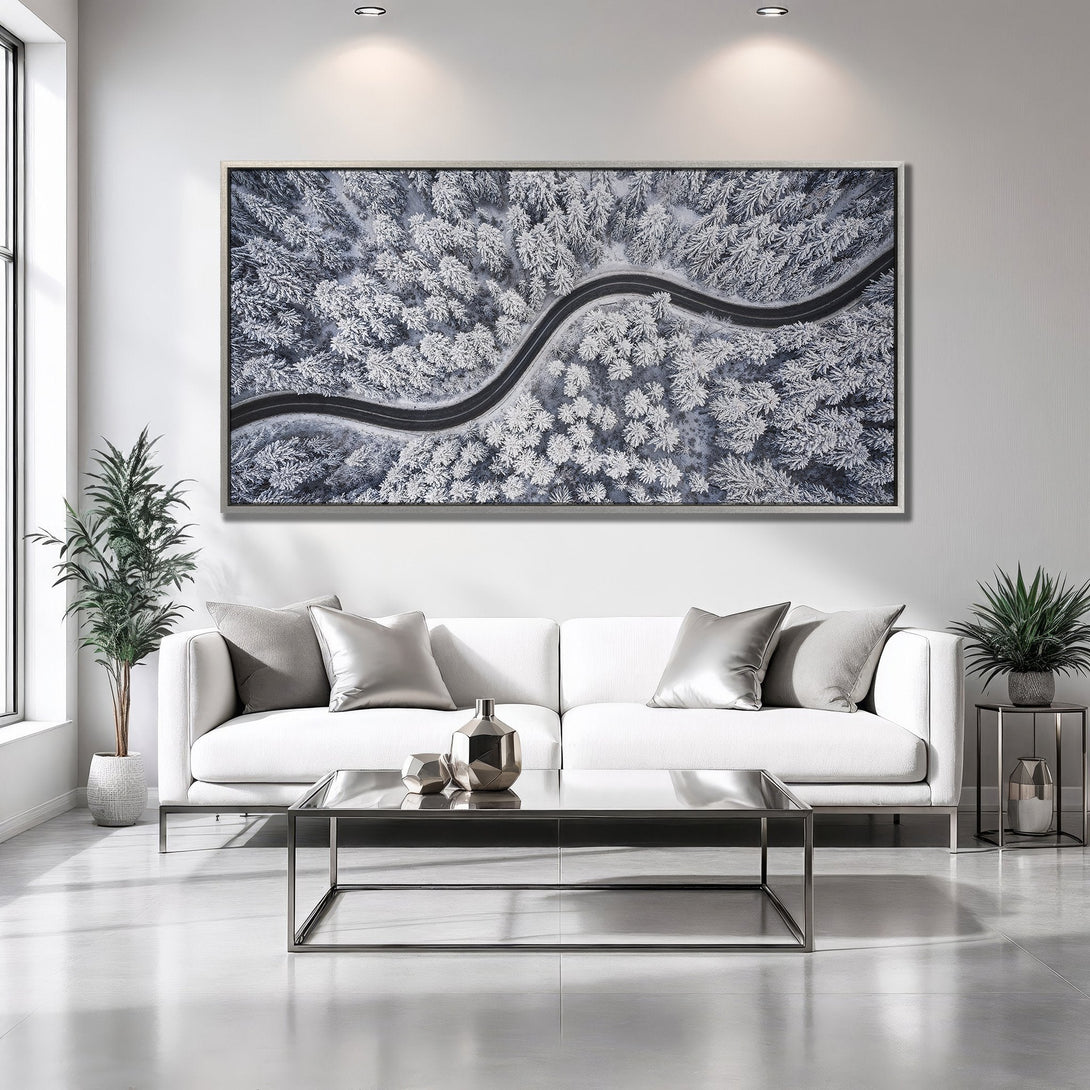 Framed Wall Art: Aerial view of a snowy forest road in a minimalist interior. Stunning black, white, and gray color palette. Perfect for modern decor.