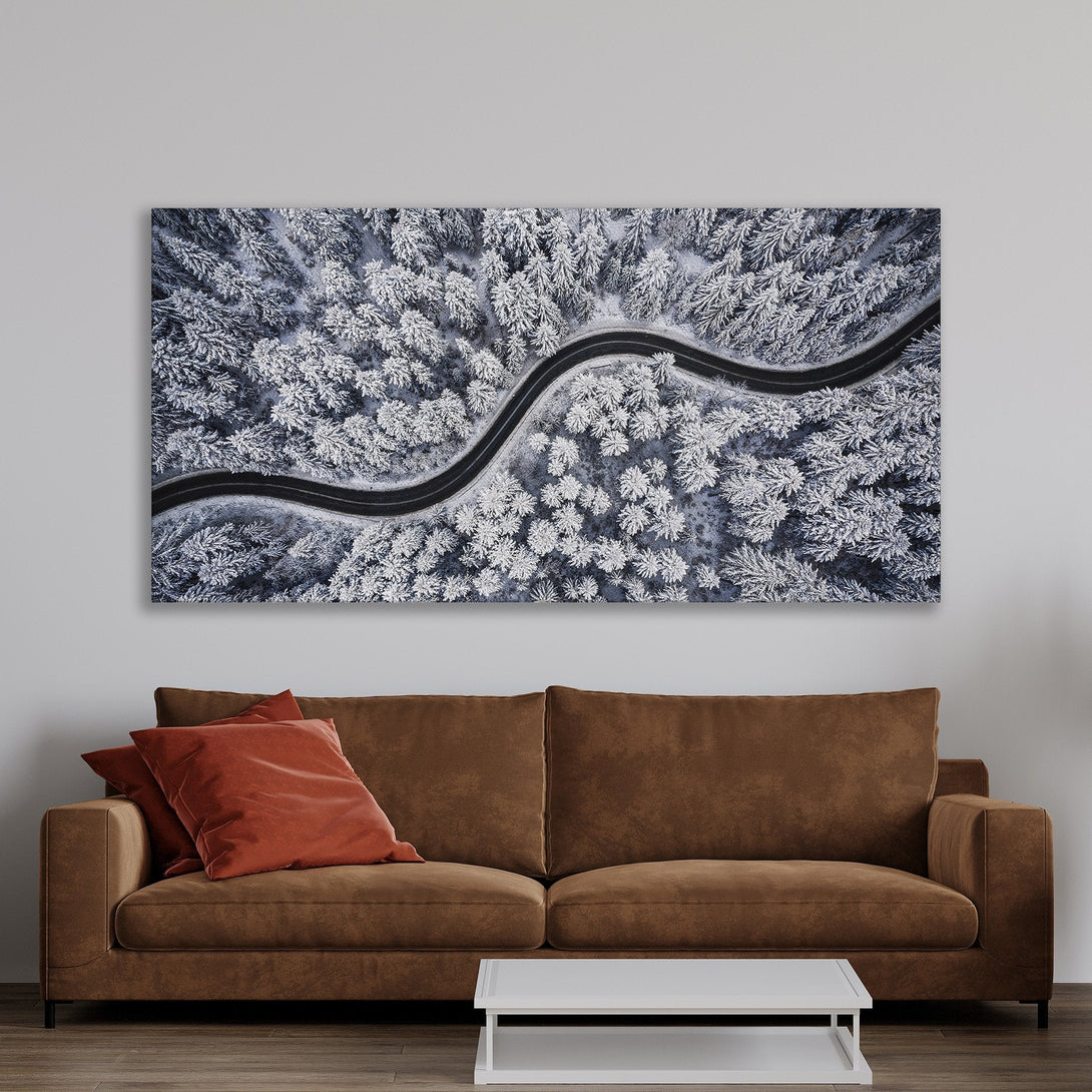 Framed Wall Art Canvas Print of a snowy forest road. Stunning aerial view in cool blue, white, and black tones. Perfect for modern home decor.