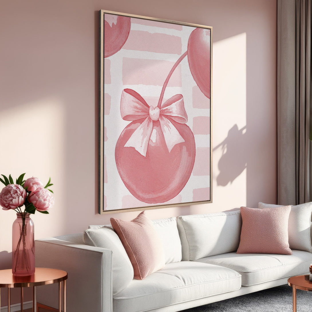 Framed Wall Art featuring a whimsical pink watercolor cherry with a bow. Soft, blush pink color palette, perfect for adding a touch of elegance to your space.