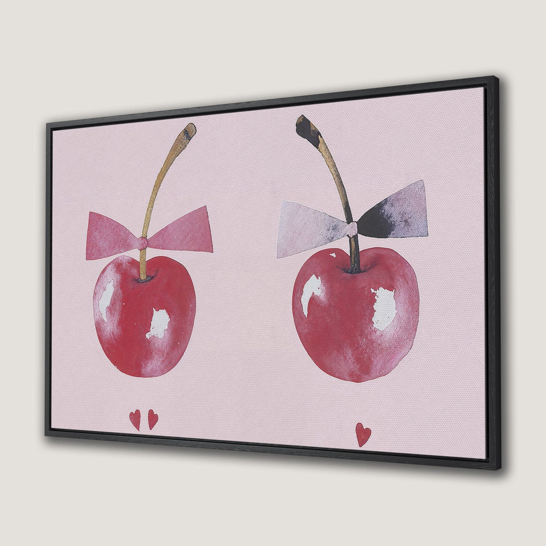 Framed Wall Art featuring watercolor cherries with bows. Soft pink background and red color palette. Perfect for adding a touch of whimsy to your space.