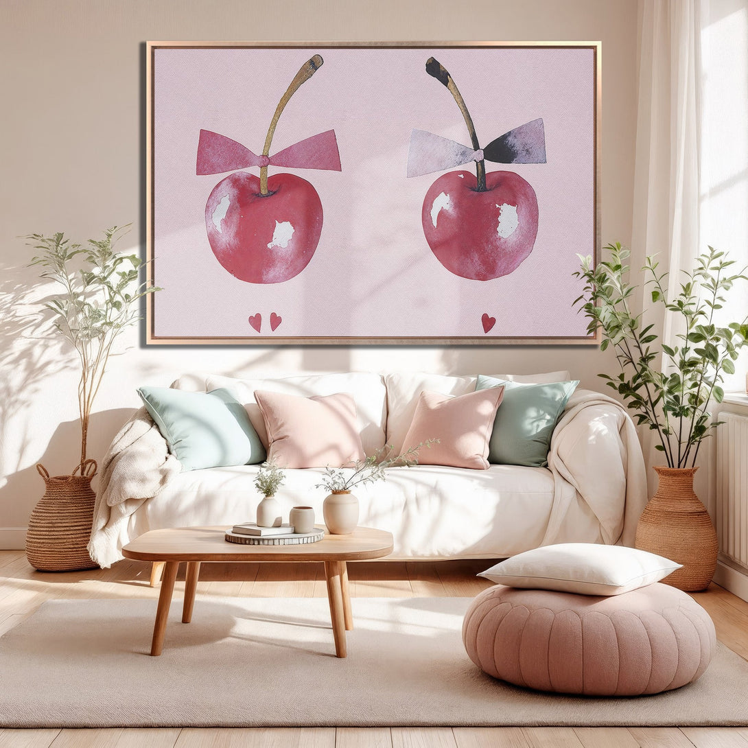 Framed Wall Art featuring watercolor cherries with bows, displayed in a cozy living room. Soft pink and red color palette, perfect for adding a touch of charm.