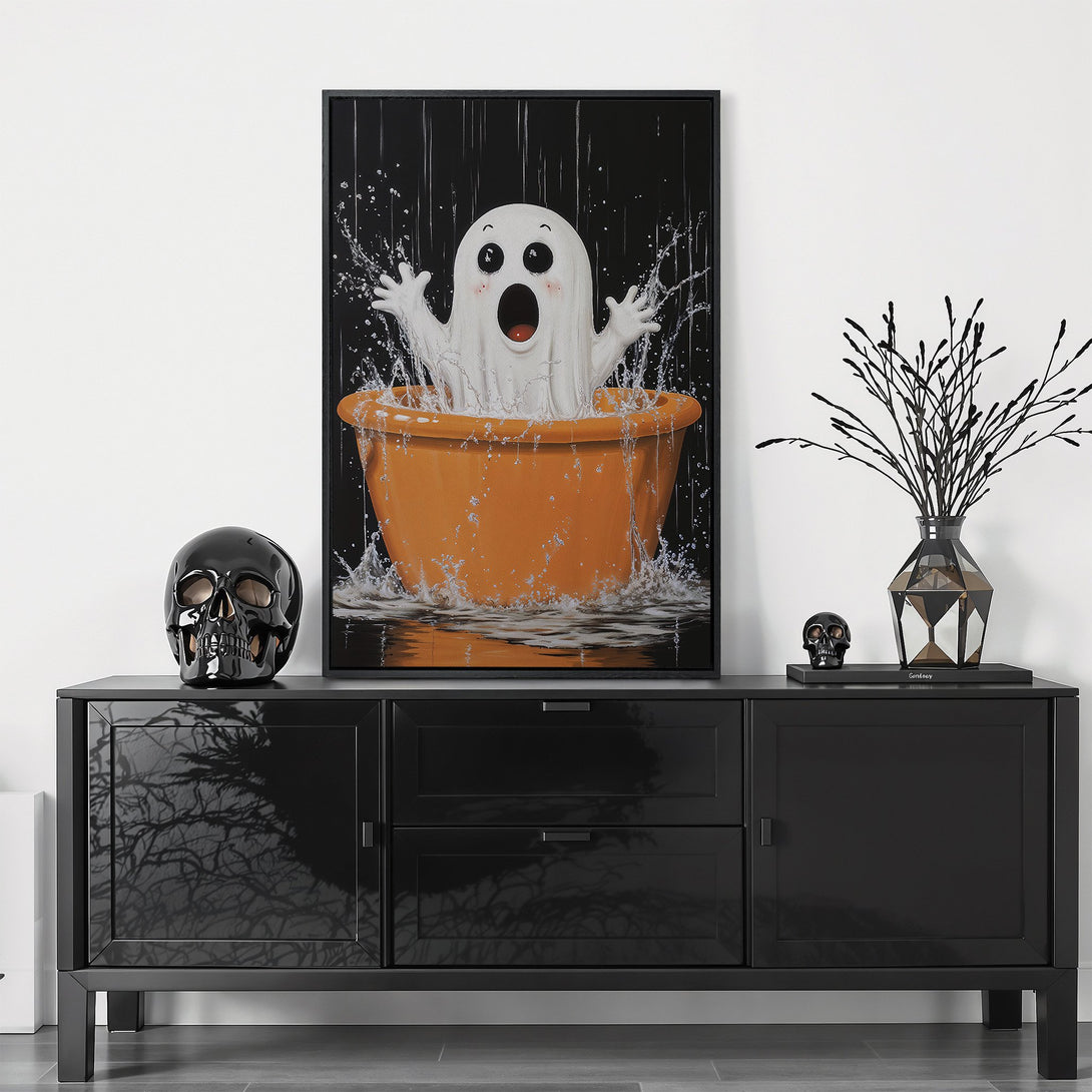 Framed Wall Art featuring a cute ghost in an orange tub. Playful style with a black, white, and orange color palette. Perfect Halloween decor!