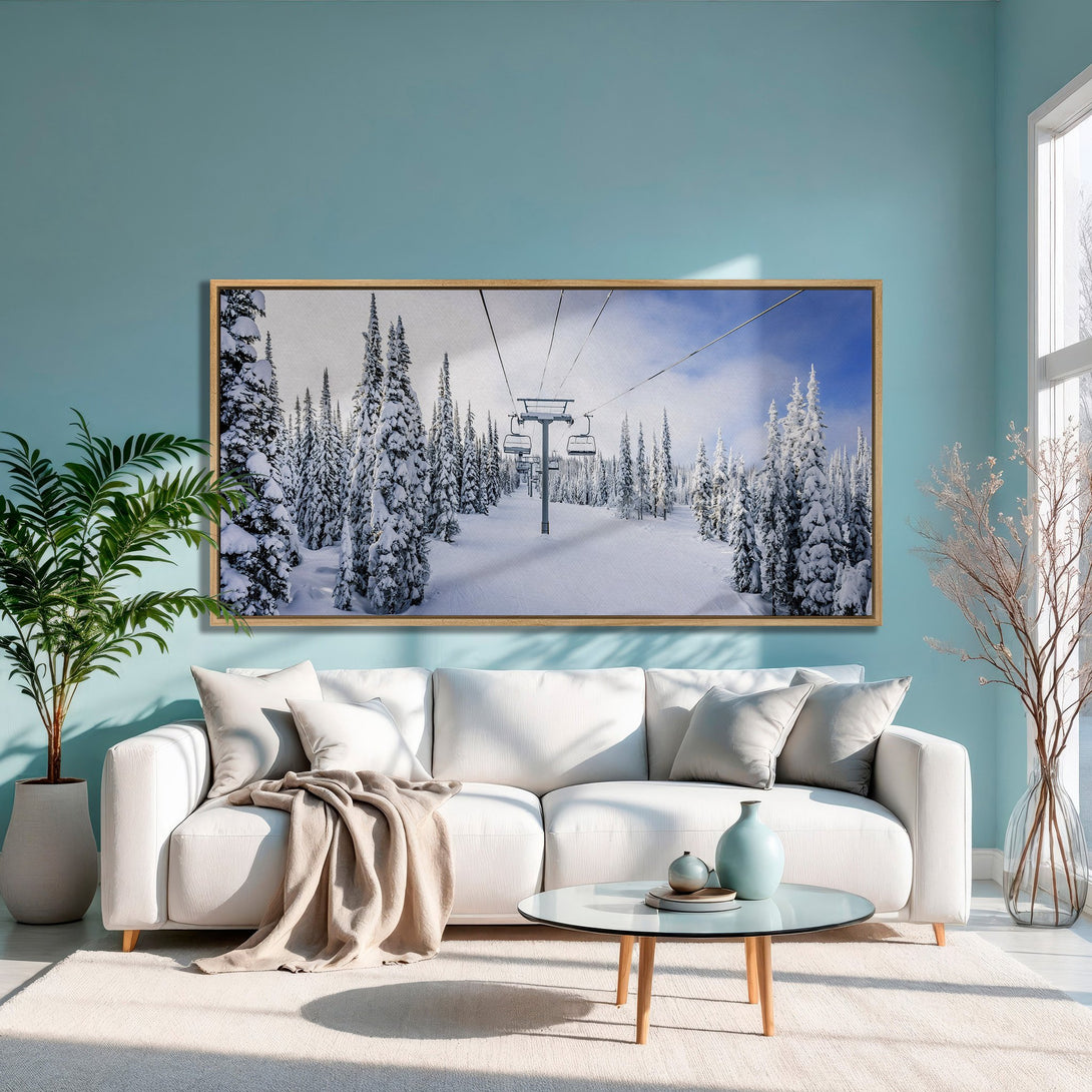Framed Wall Art of snowy ski lift scene in a modern living room. Cool blue, white, and natural wood tones create a serene atmosphere.
