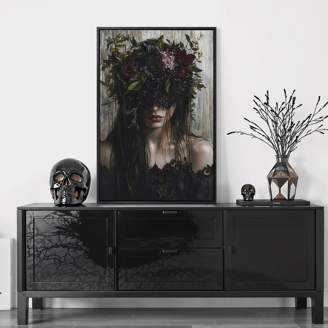 Framed Wall Art featuring a dark, gothic portrait with a floral headdress. Moody, dramatic style with a black, grey, and burgundy color palette. Elevate your space!