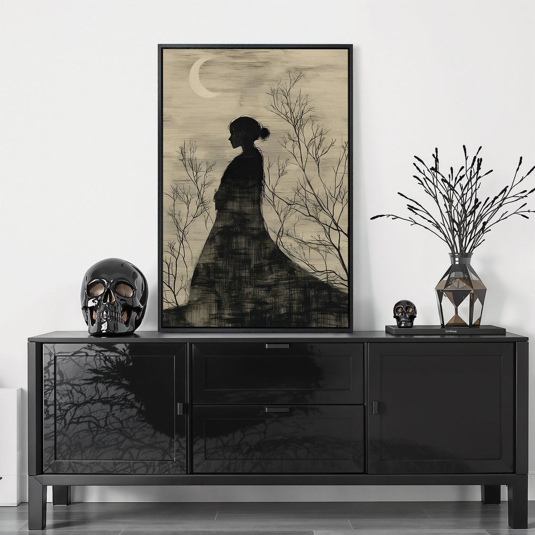 Framed Wall Art featuring a silhouette of a woman under a moon, in a minimalist black and beige color palette. Perfect for modern home decor.