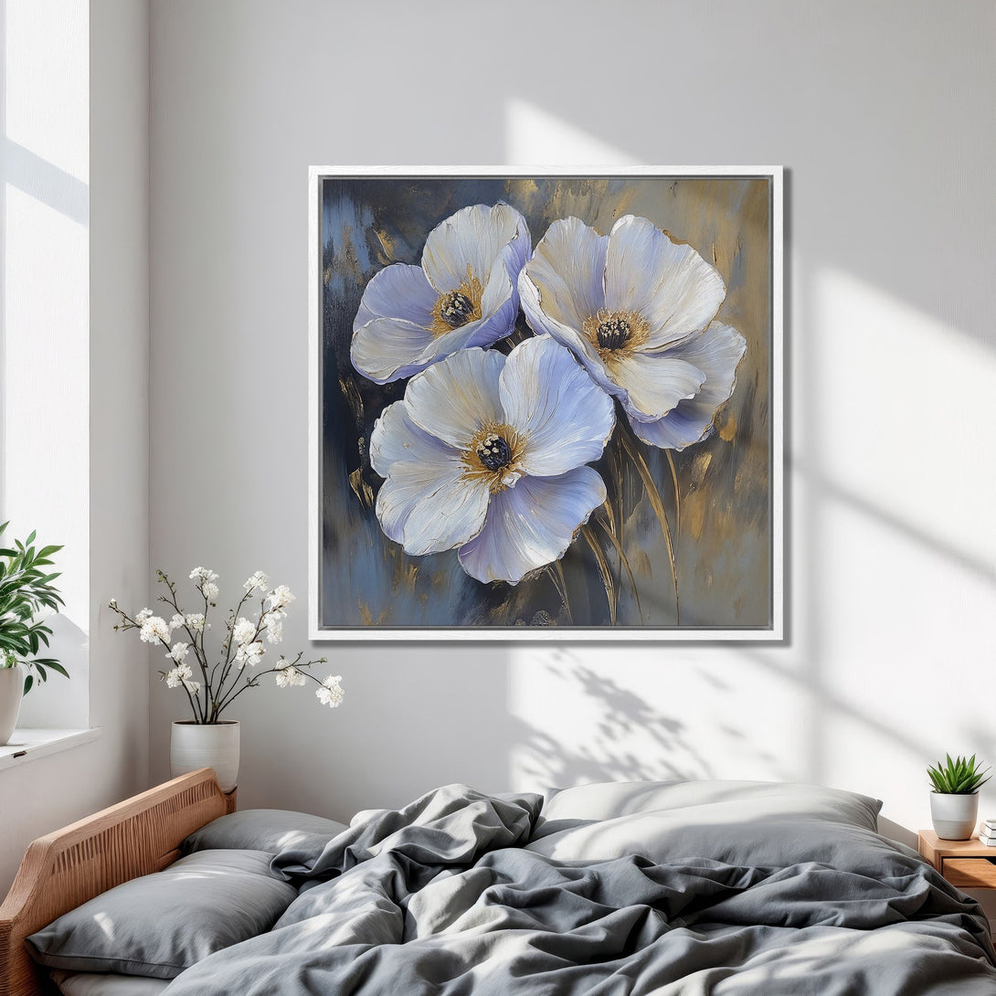 Framed Wall Art featuring a floral oil painting in a bedroom. Soft white and blue flowers with gold accents. Modern, elegant decor.