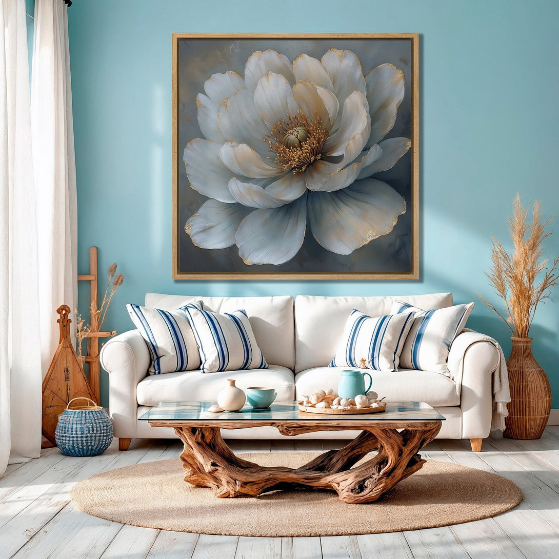 Framed Wall Art featuring a large, elegant white flower with gold accents. Perfect for coastal decor, the artwork has a soft, muted color palette.