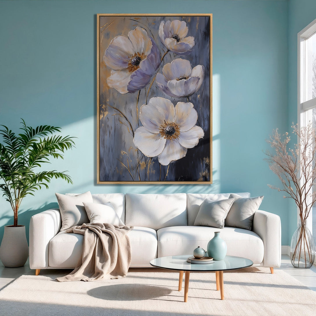 Framed Wall Art: Elegant floral canvas print in a modern living room. Features white and purple flowers on a gray background with a gold accent, creating a serene atmosphere.