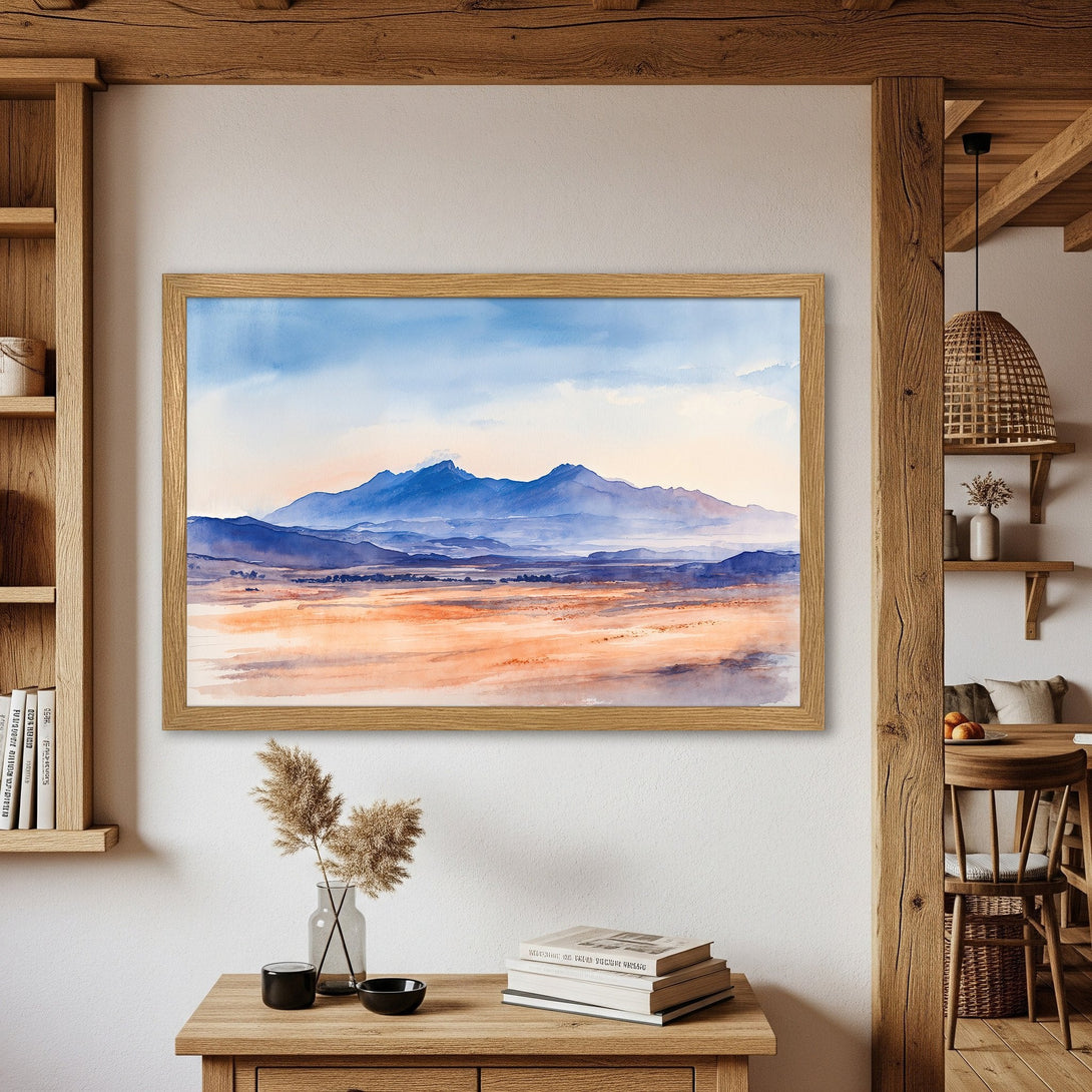 Framed Poster featuring a watercolor landscape of mountains in blue and orange hues, perfect for home decor.
