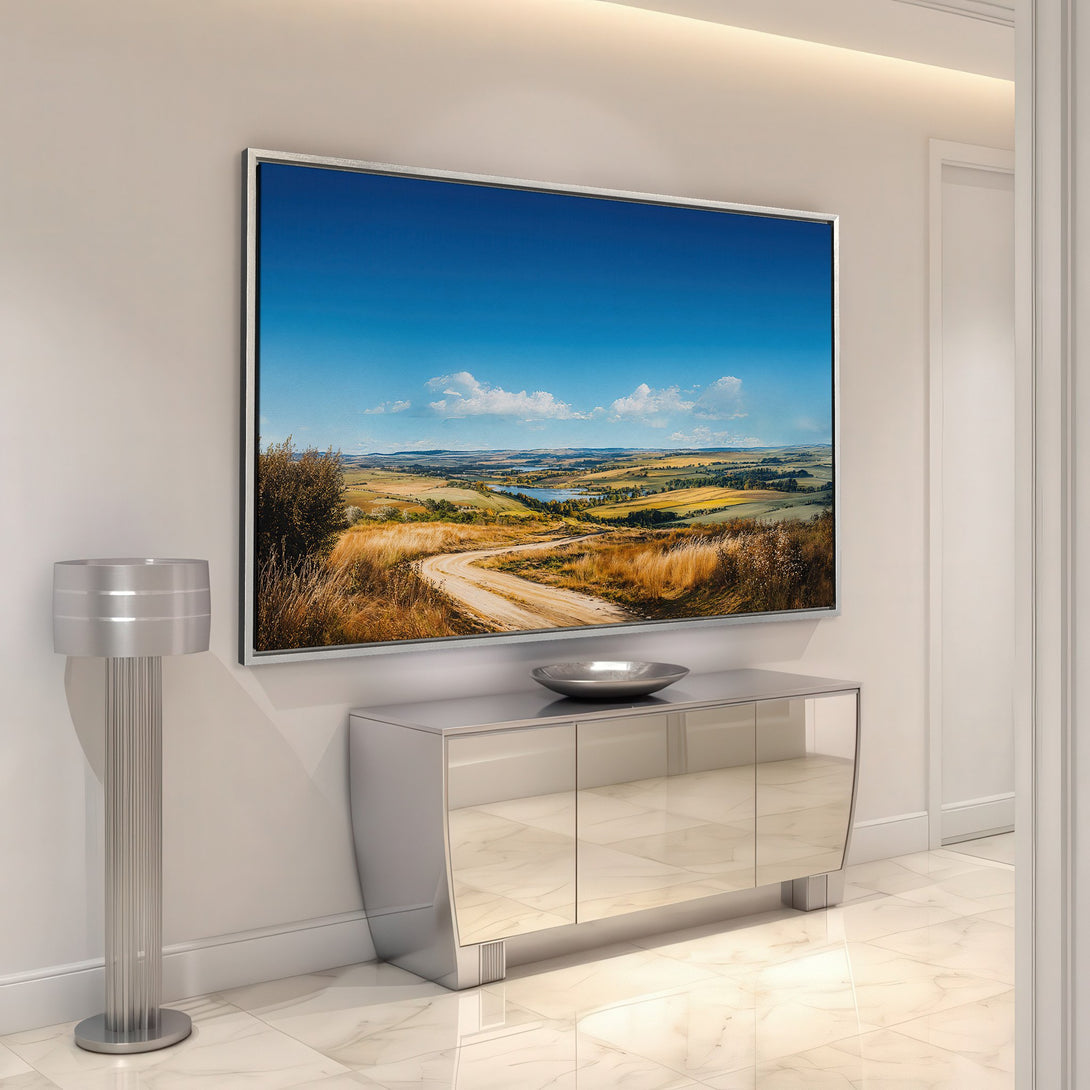 Framed Wall Art featuring a landscape scene with a blue sky and golden fields, displayed in a modern interior with a neutral color palette.
