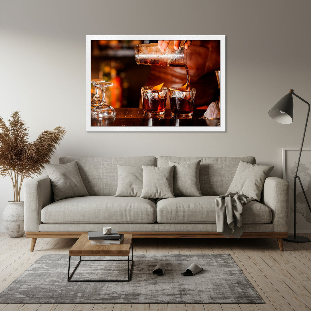 Framed Poster of a bartender pouring a cocktail. Warm, inviting colors with a focus on the amber liquid. Perfect for home decor.