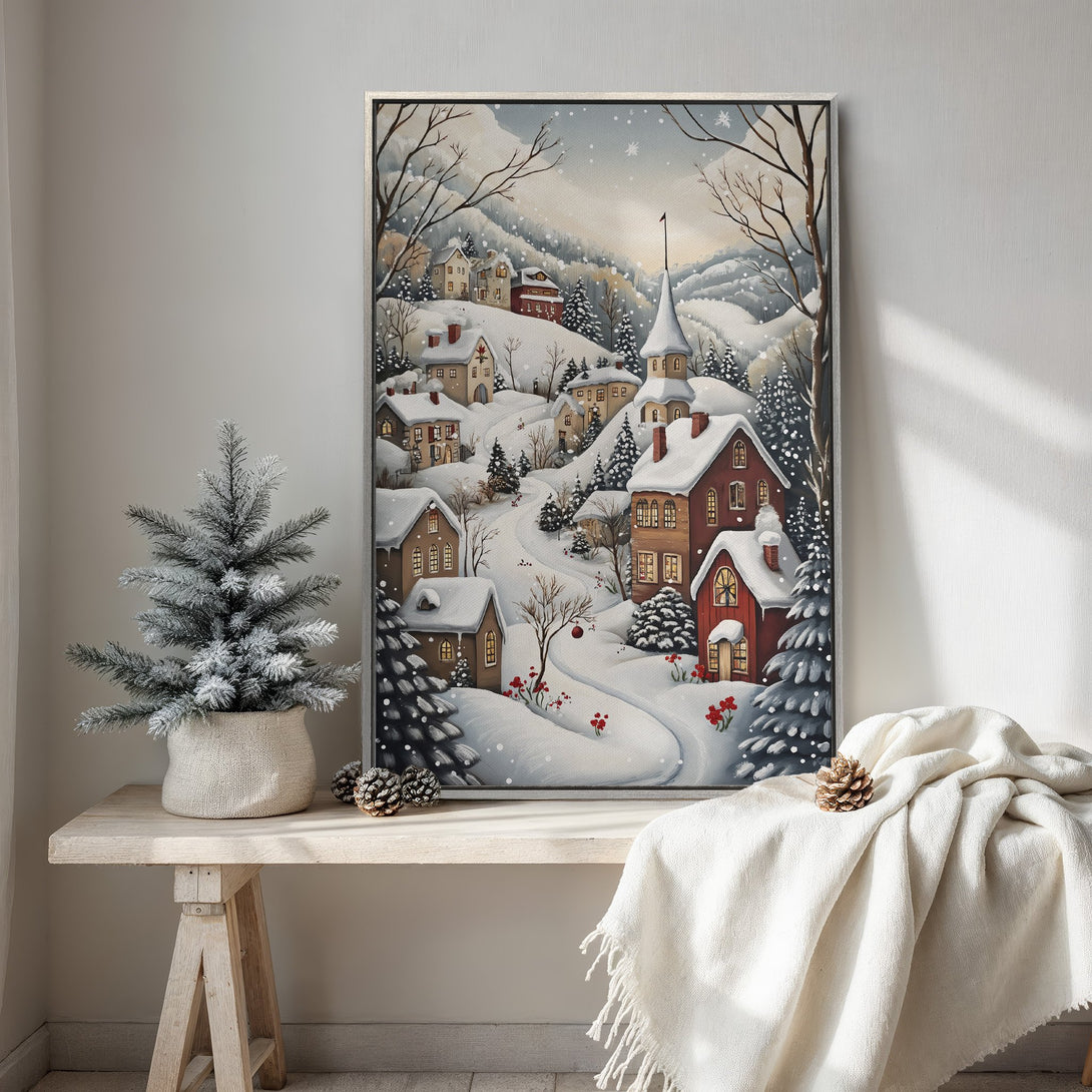 Framed Wall Art of a snowy winter village scene. Watercolor style with a warm, inviting color palette of reds, browns, and whites. Perfect for cozy home decor.