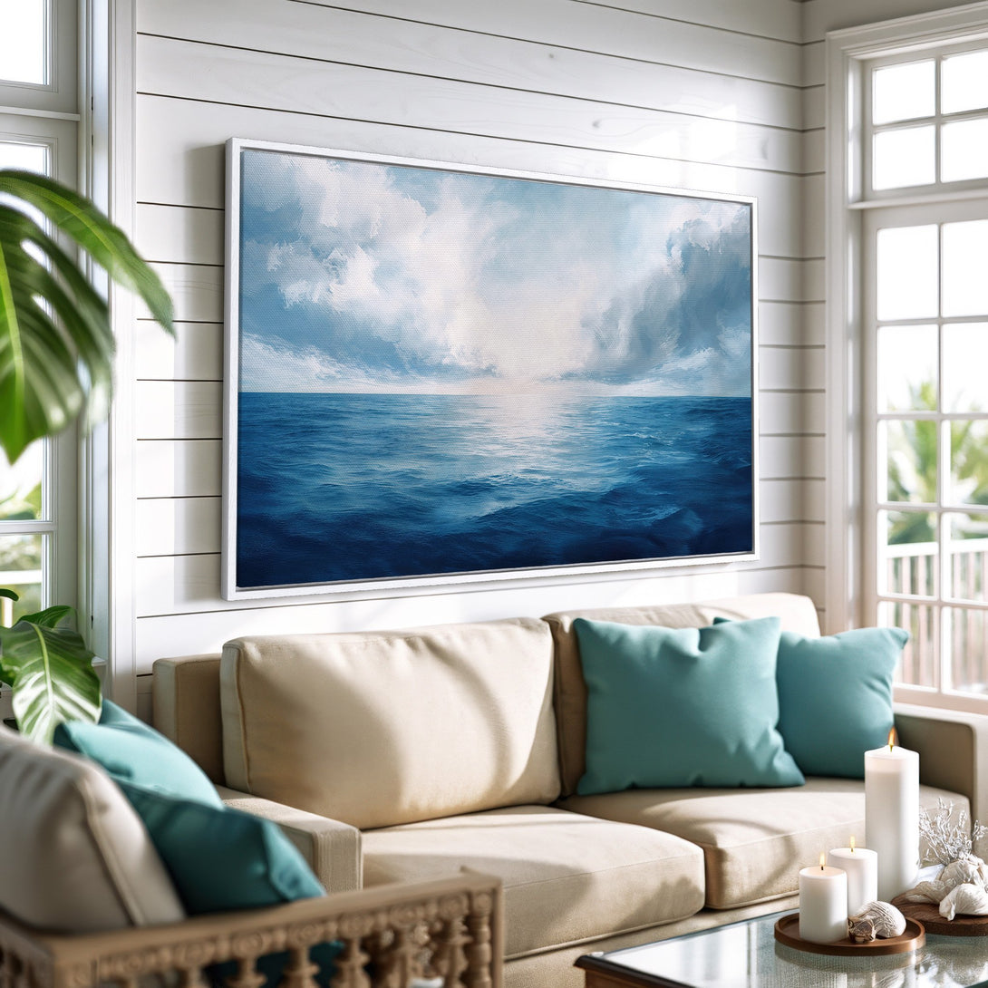 Framed Wall Art: Ocean scene canvas print in a coastal living room. Blue and white seascape art adds a serene touch to any space.