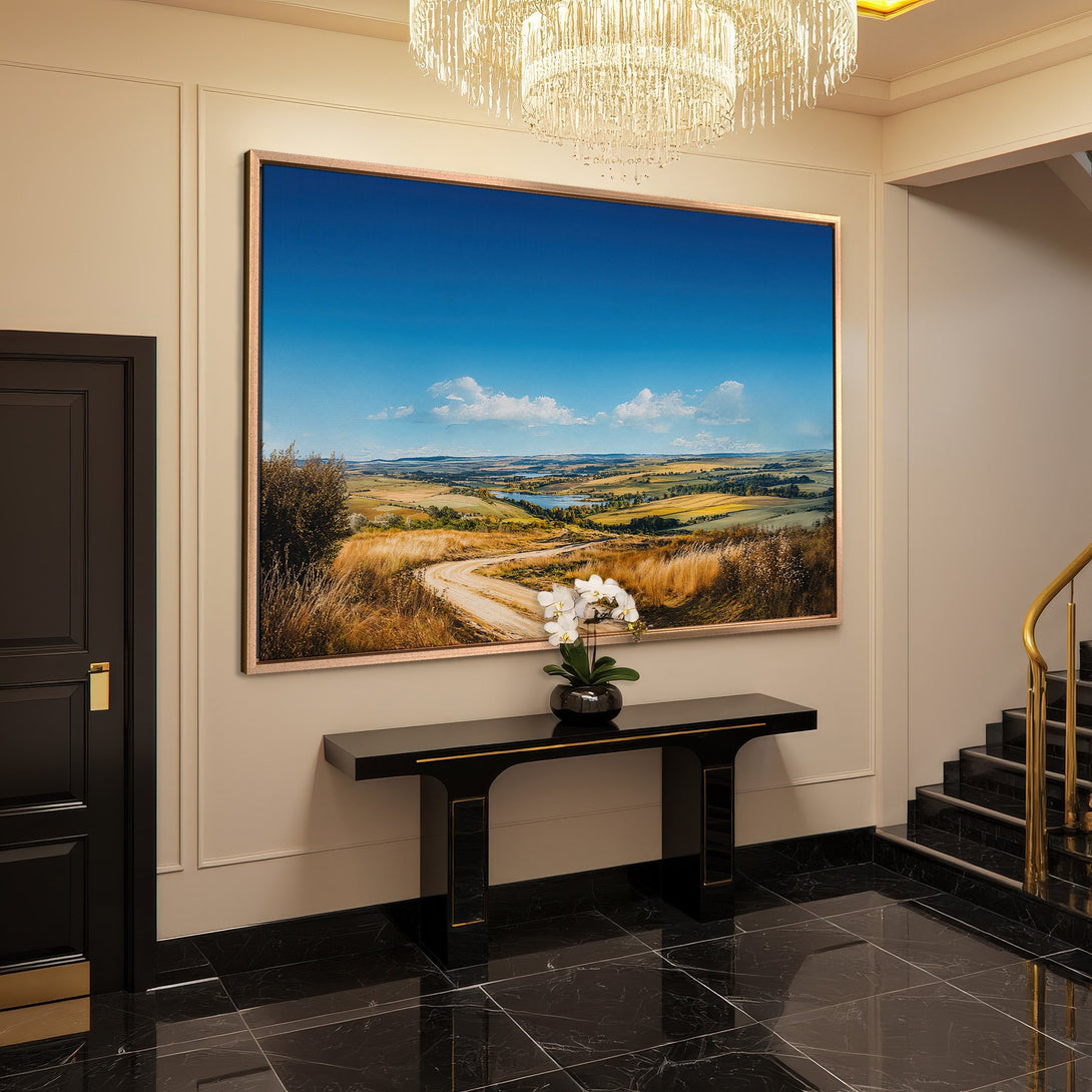 Framed Wall Art landscape print with blue sky and golden fields, displayed in a luxurious interior. Warm, inviting color palette.