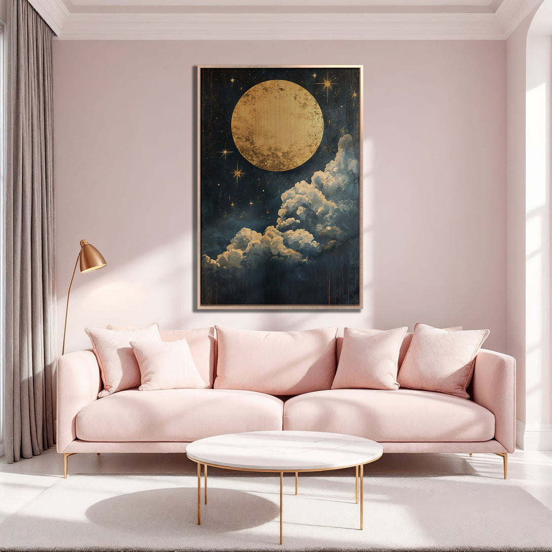 Framed Wall Art featuring a celestial moon and cloudscape in gold and navy tones, displayed in a blush pink interior. Perfect for adding a touch of elegance.