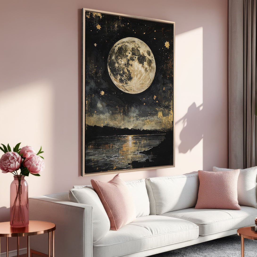 Framed Wall Art of a moonlit landscape in a modern living room. Features a dark, moody palette with gold accents and a soft pink interior.