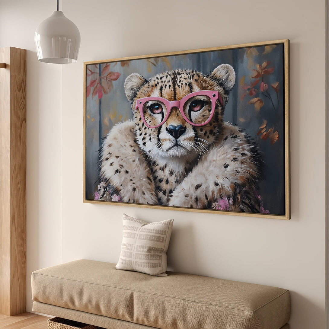 Framed Wall Art: Playful cheetah portrait with pink glasses, set in a warm, neutral interior. Perfect for adding a touch of whimsy to your home decor.