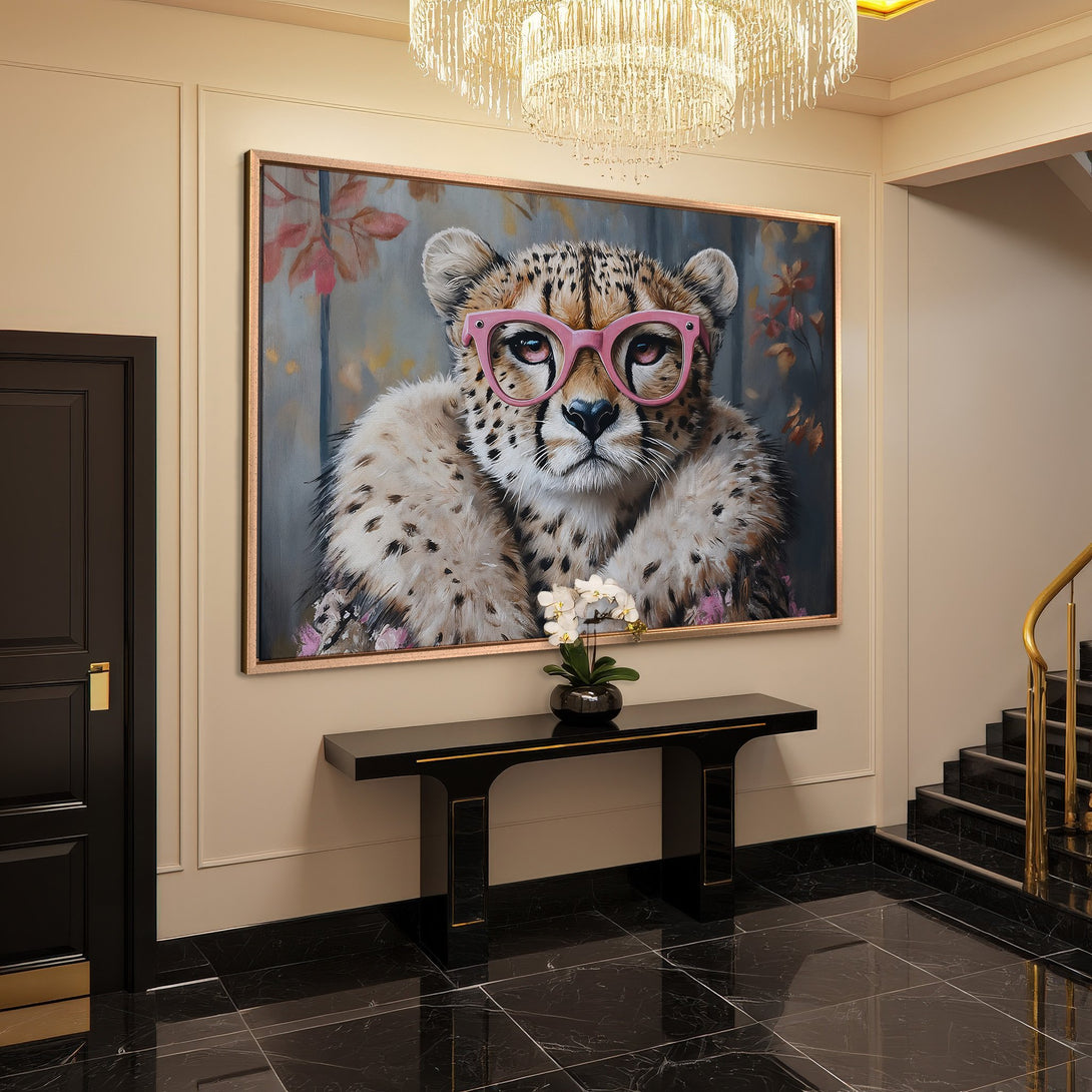 Framed Wall Art: Playful cheetah portrait with pink glasses. Warm, neutral color palette adds a touch of whimsy to any space. Elevate your home decor!