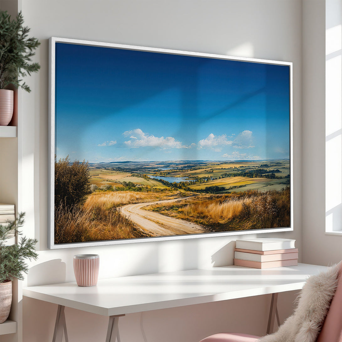 Framed Wall Art featuring a landscape with a winding road, blue sky, and warm, earthy tones. Perfect for adding a touch of nature to your home.