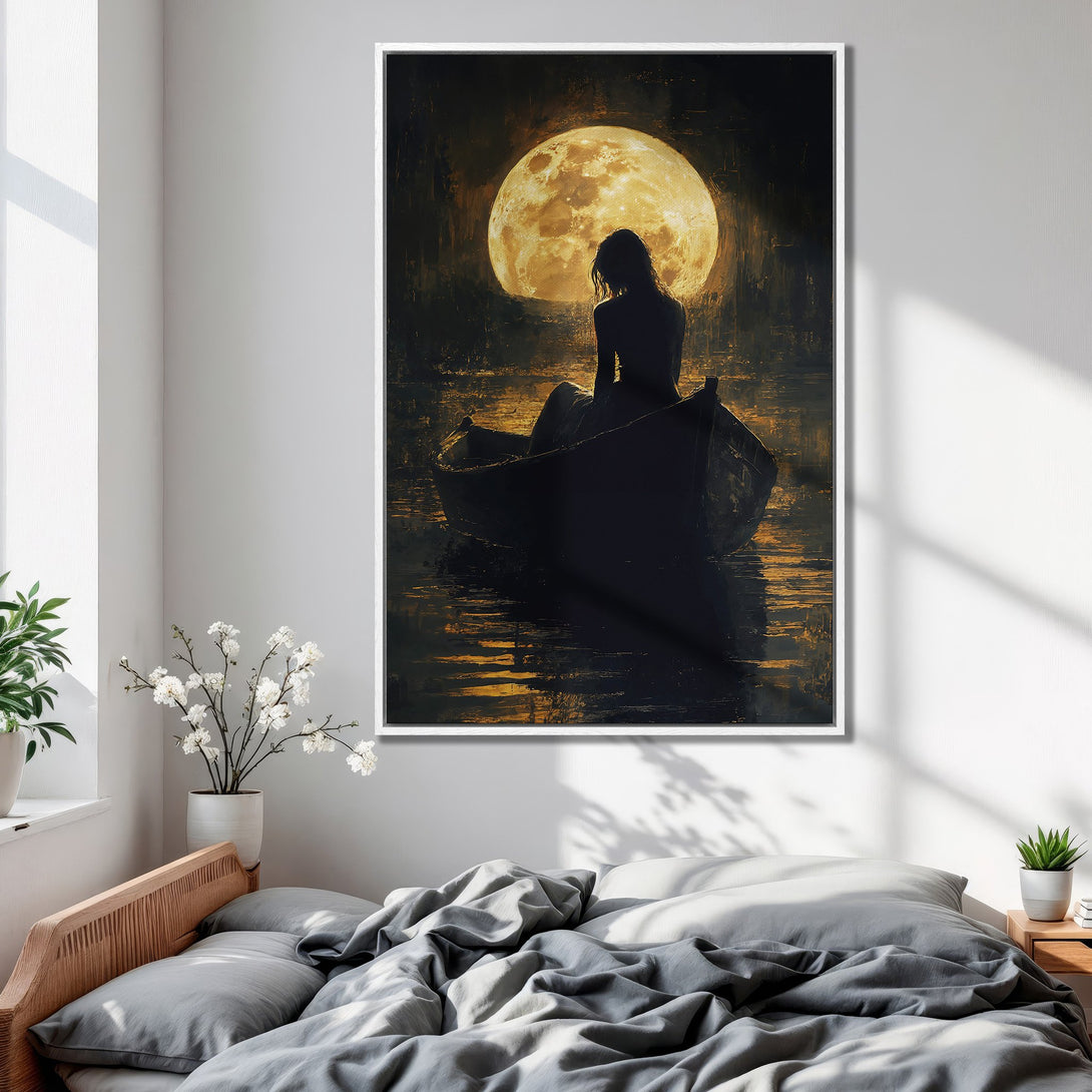 Framed Wall Art: Silhouette of woman in boat under a full moon. Moody, romantic art in a warm, golden and black color palette. Perfect bedroom decor.
