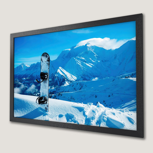 Framed Poster of a snowboard in a snowy mountain landscape, vibrant blue and white color palette, perfect for winter decor.