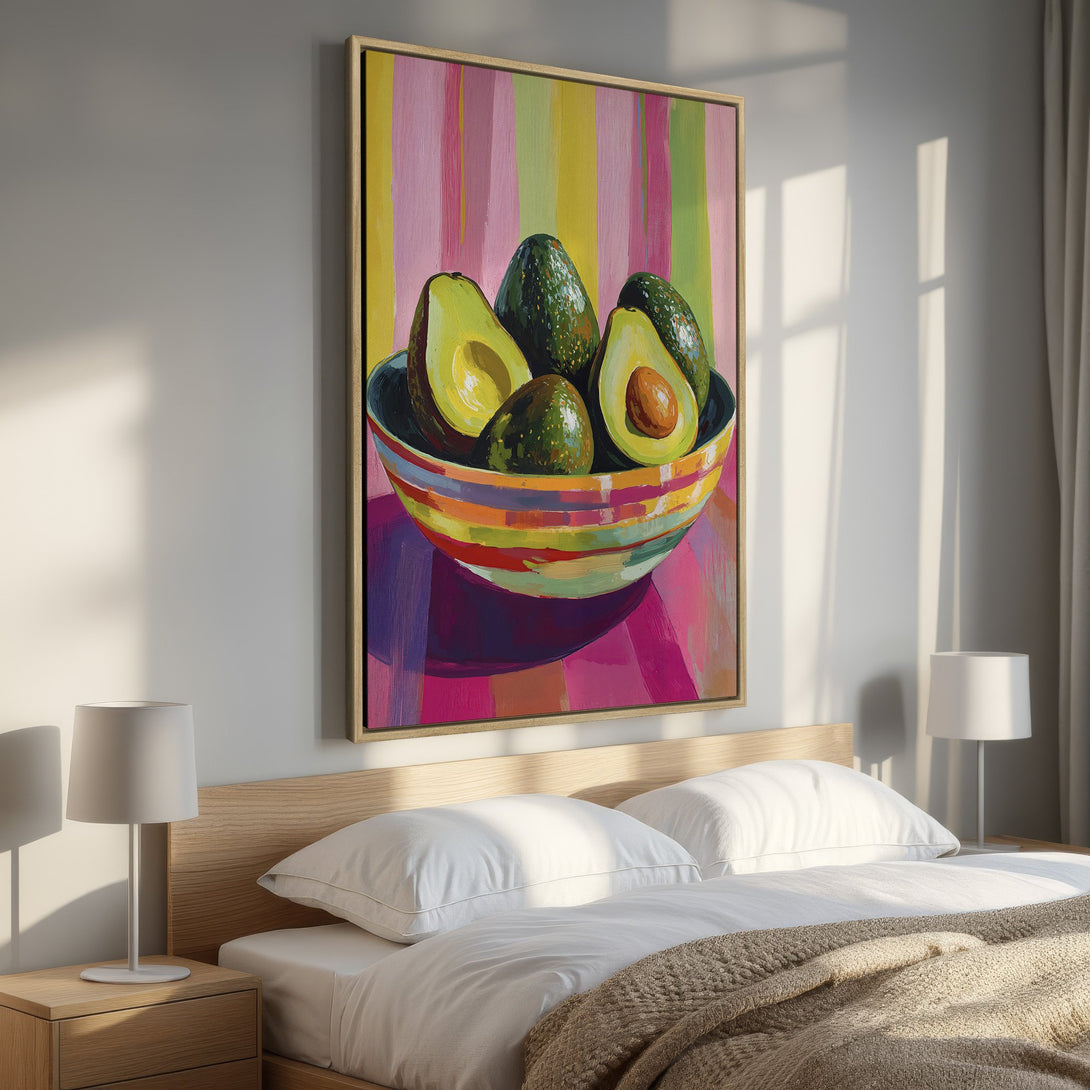 Framed Wall Art: Vibrant avocado still life painting in a bedroom. Colorful, modern artwork with a pink, green, and yellow palette. Perfect for kitchen or dining room.