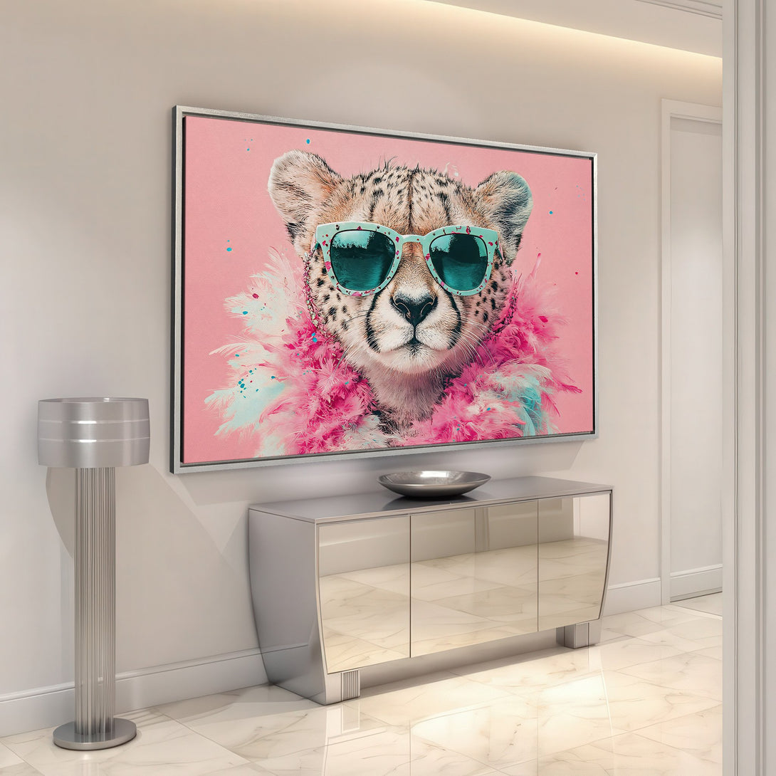 Framed Wall Art featuring a stylish cheetah wearing sunglasses and a pink boa. Pop art style with a pink and teal color palette. Elevate your decor!