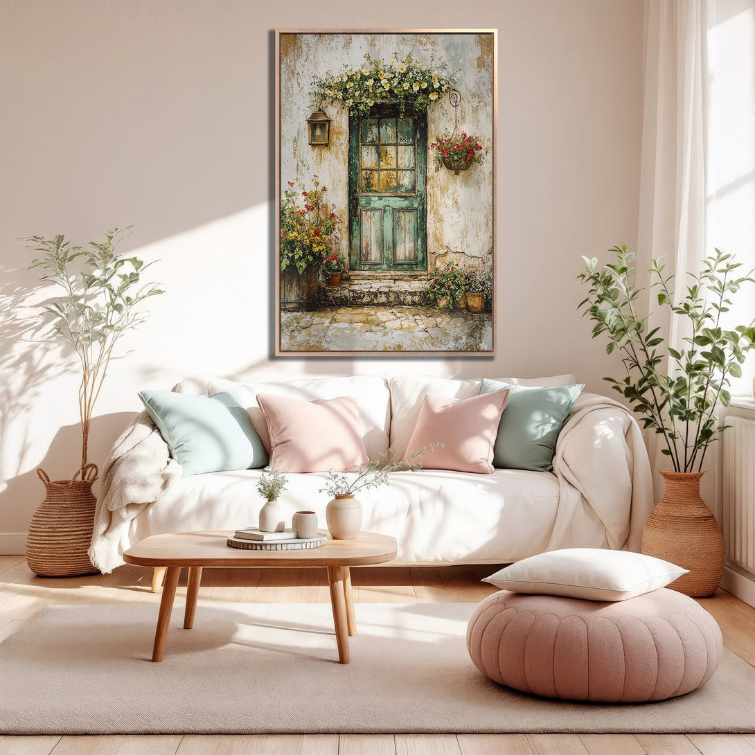 Framed Wall Art featuring a rustic door scene with flowers, displayed in a cozy interior. Soft, warm color palette with greens, pinks, and creams.