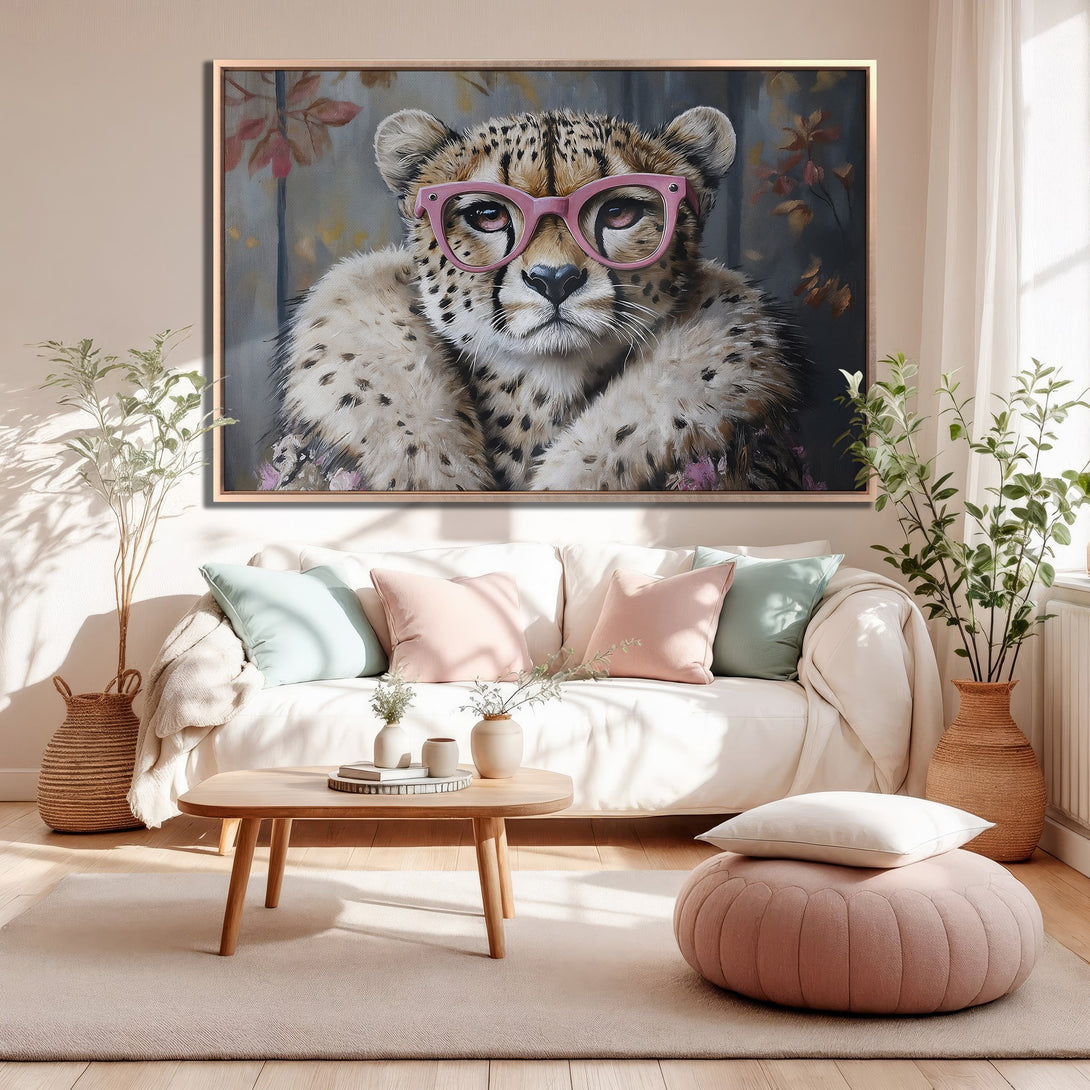 Framed Wall Art: Whimsical cheetah portrait with pink glasses in a cozy interior. Soft, neutral color palette with pops of pink and green. Perfect home decor!