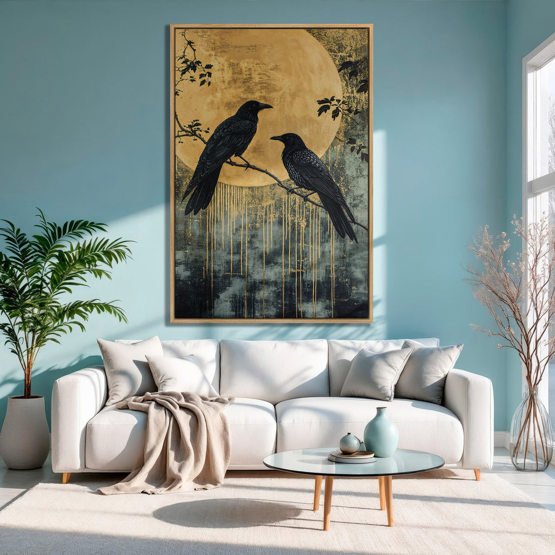 Framed Wall Art featuring two black crows on a branch, against a golden moon. Elegant, modern style with a teal and gold color palette. Perfect for home decor.