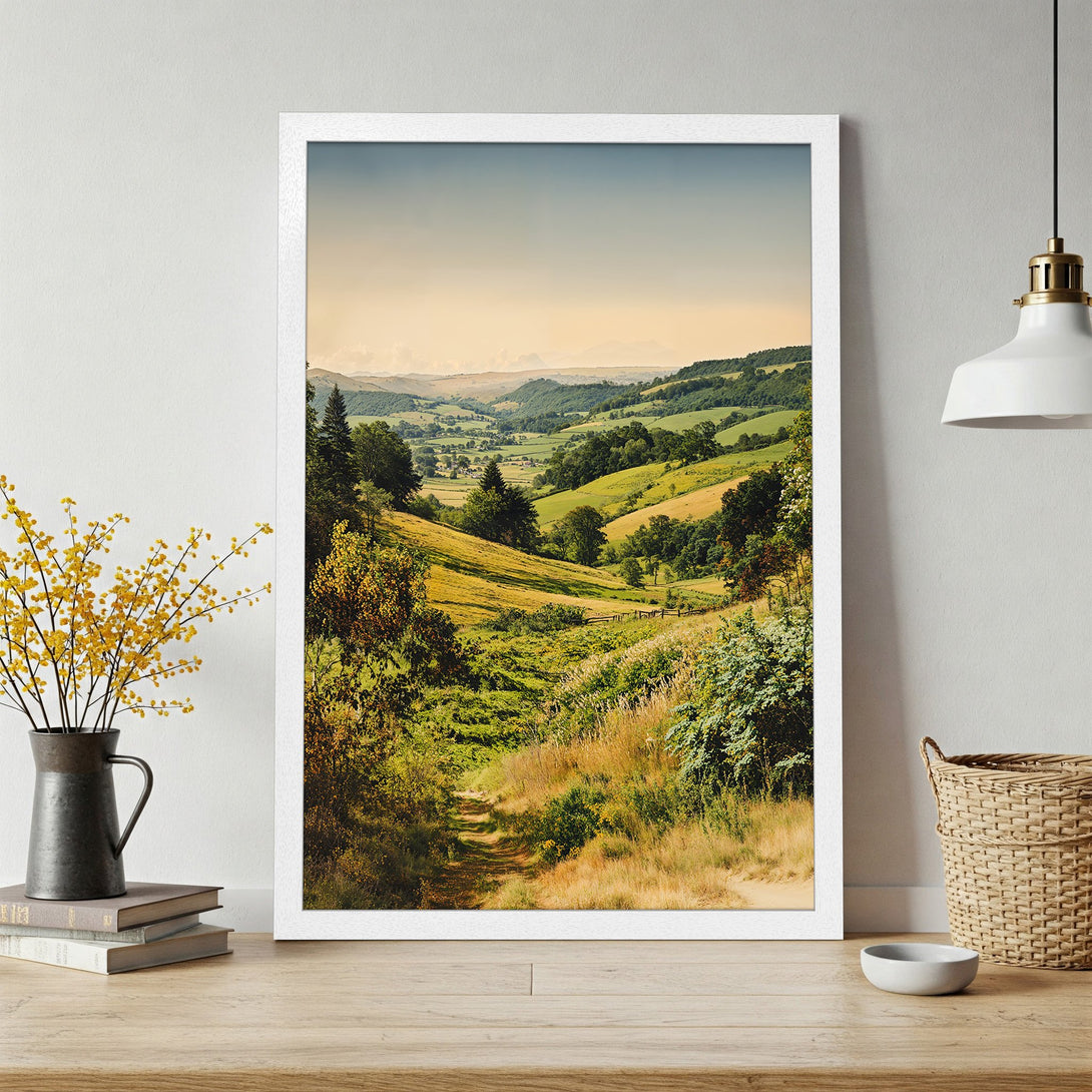 Framed Poster of a serene landscape with rolling hills, warm green & yellow tones. Perfect wall art for any room!