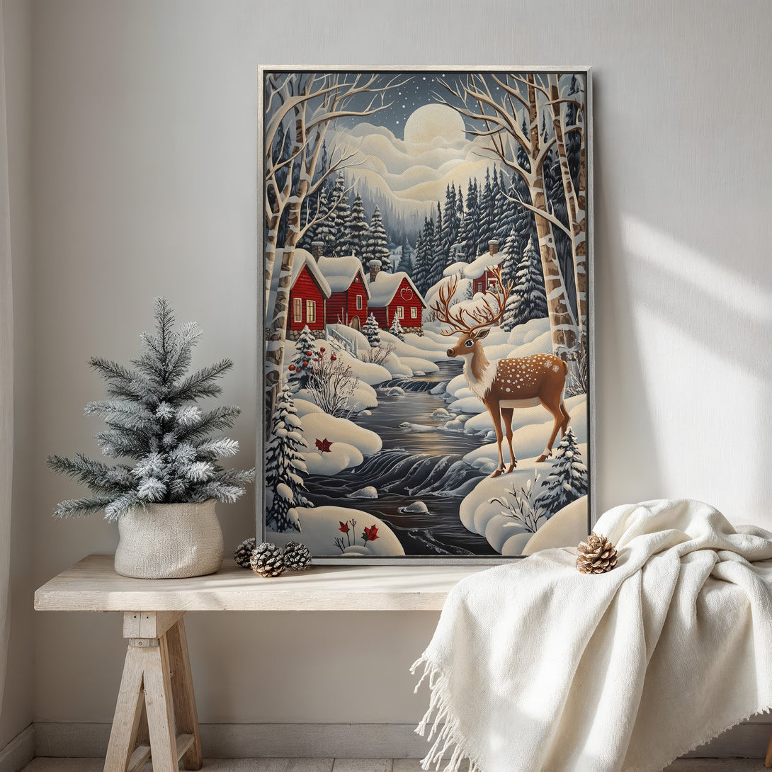 Framed Wall Art featuring a winter landscape with a deer, red houses, and snowy trees. Beautiful blue, white, and red color palette. Perfect for cozy home decor!