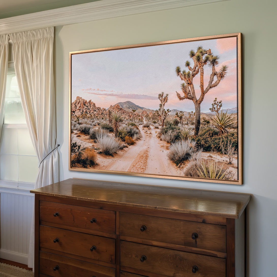 Framed Wall Art featuring a desert landscape with Joshua trees. Earthy tones and a warm color palette create a serene, natural aesthetic.