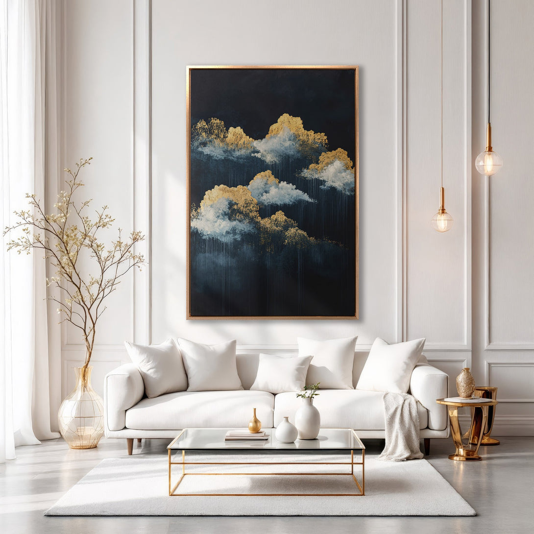 Framed Wall Art featuring an abstract cloudscape in gold and navy. Modern art canvas print adds elegance to a white interior.