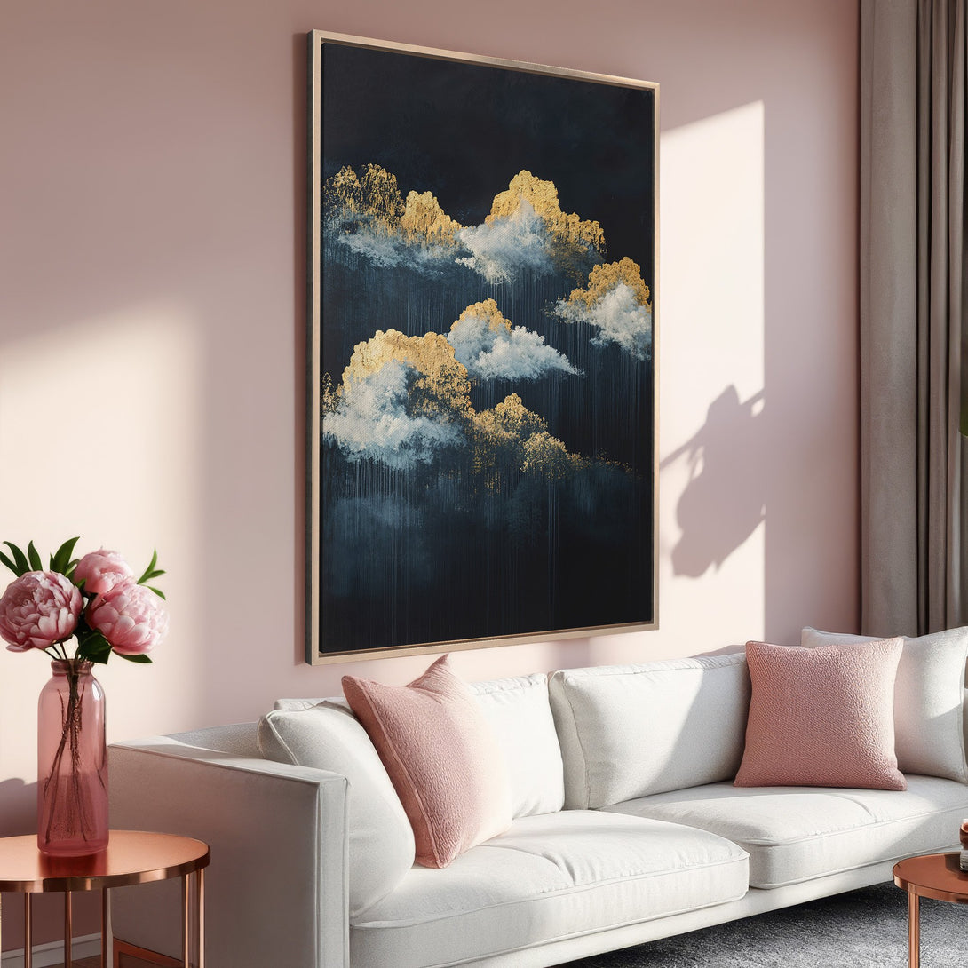 Framed Wall Art featuring abstract gold and blue cloudscape. Modern art print in a blush pink interior. Elevate your space with this stunning canvas.