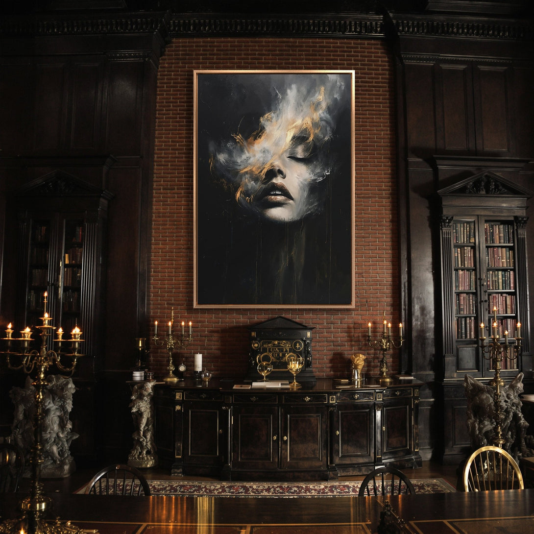Framed Wall Art: Dramatic portrait canvas print in a dark, moody interior. Features a woman's face with a black, white, and gold color palette. Perfect for a statement piece.